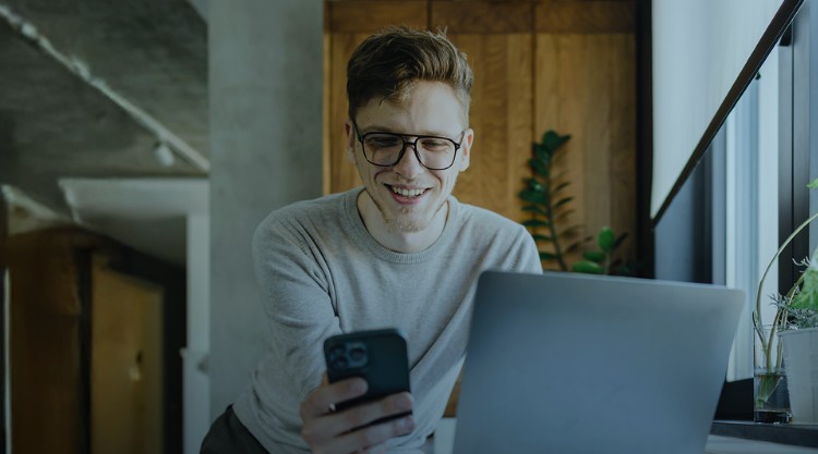 Young Male Writer Reading E-mails On A Tablet at office